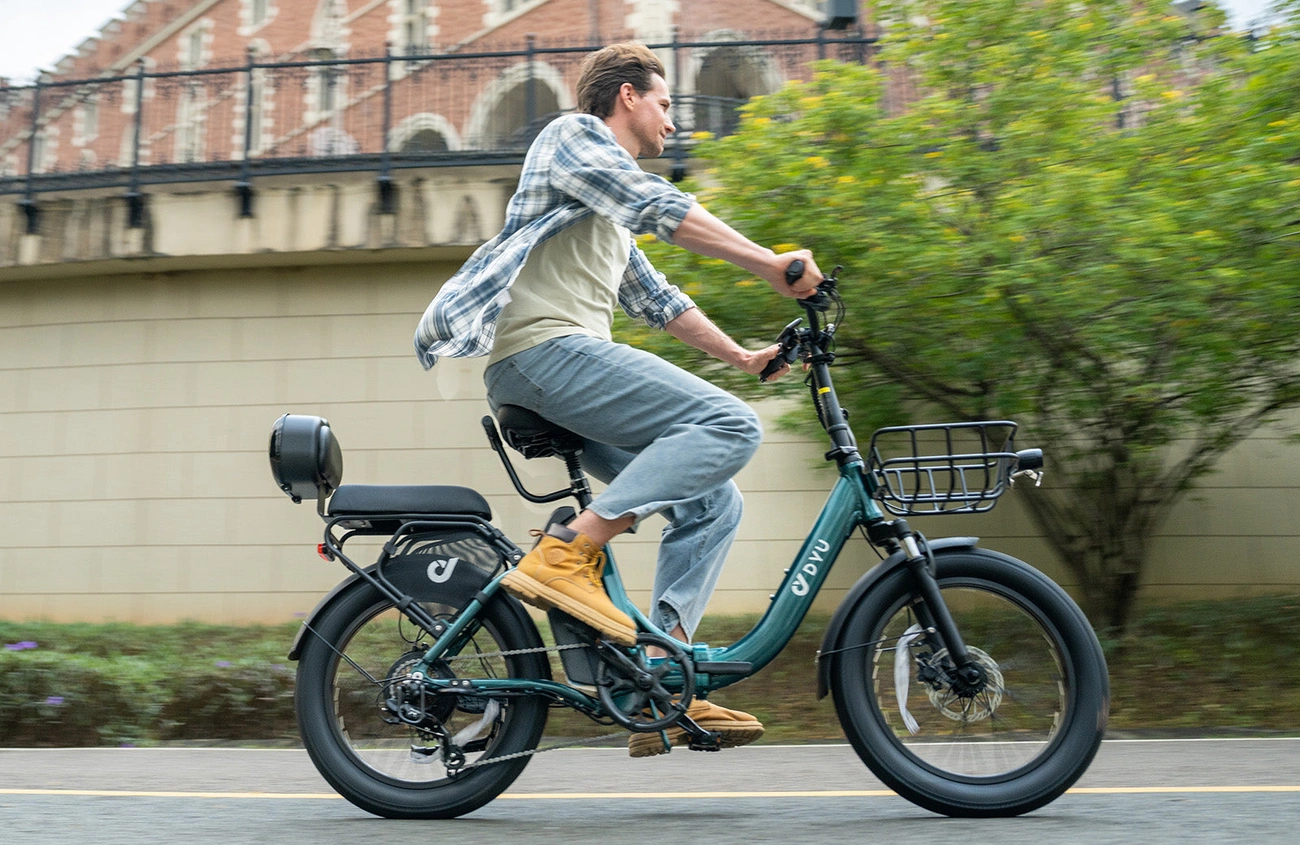 DYU C9 rider in an outdoor city scene showing low central e-bike battery placement