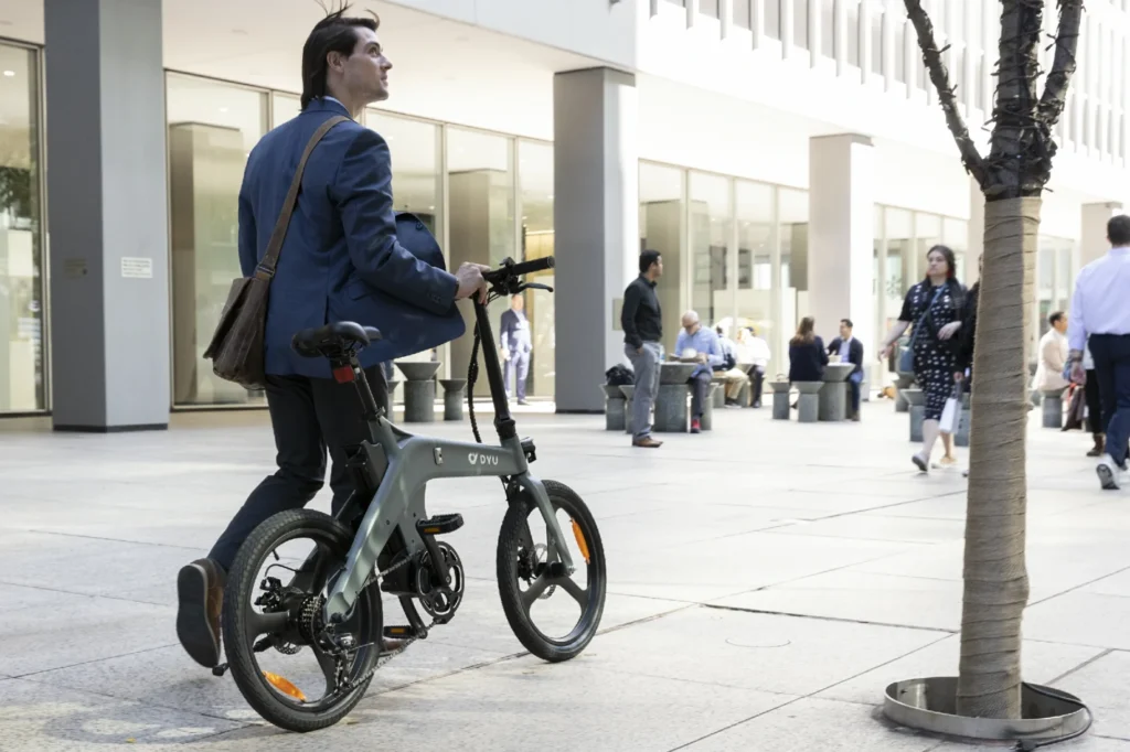 DYU T1 rider using pedal assistance on a downtown route