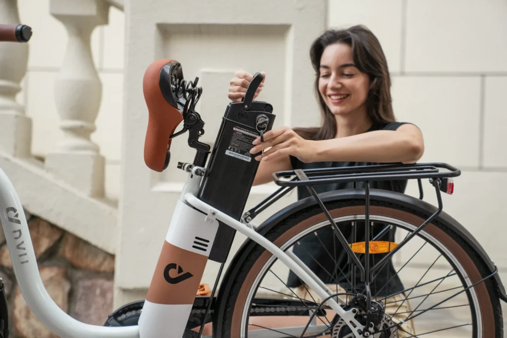 DYU-branded removable e-bike battery held outdoors during a mount inspection