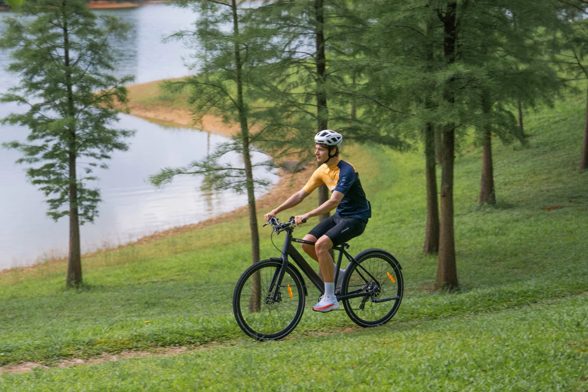 DYU e-bike rider beside a lake after a careful wet-weather ride